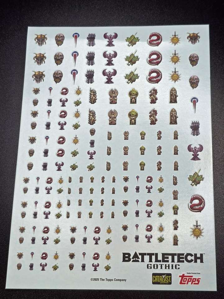 A sheet of transfer decals featuring the various Gothic faction emblems
